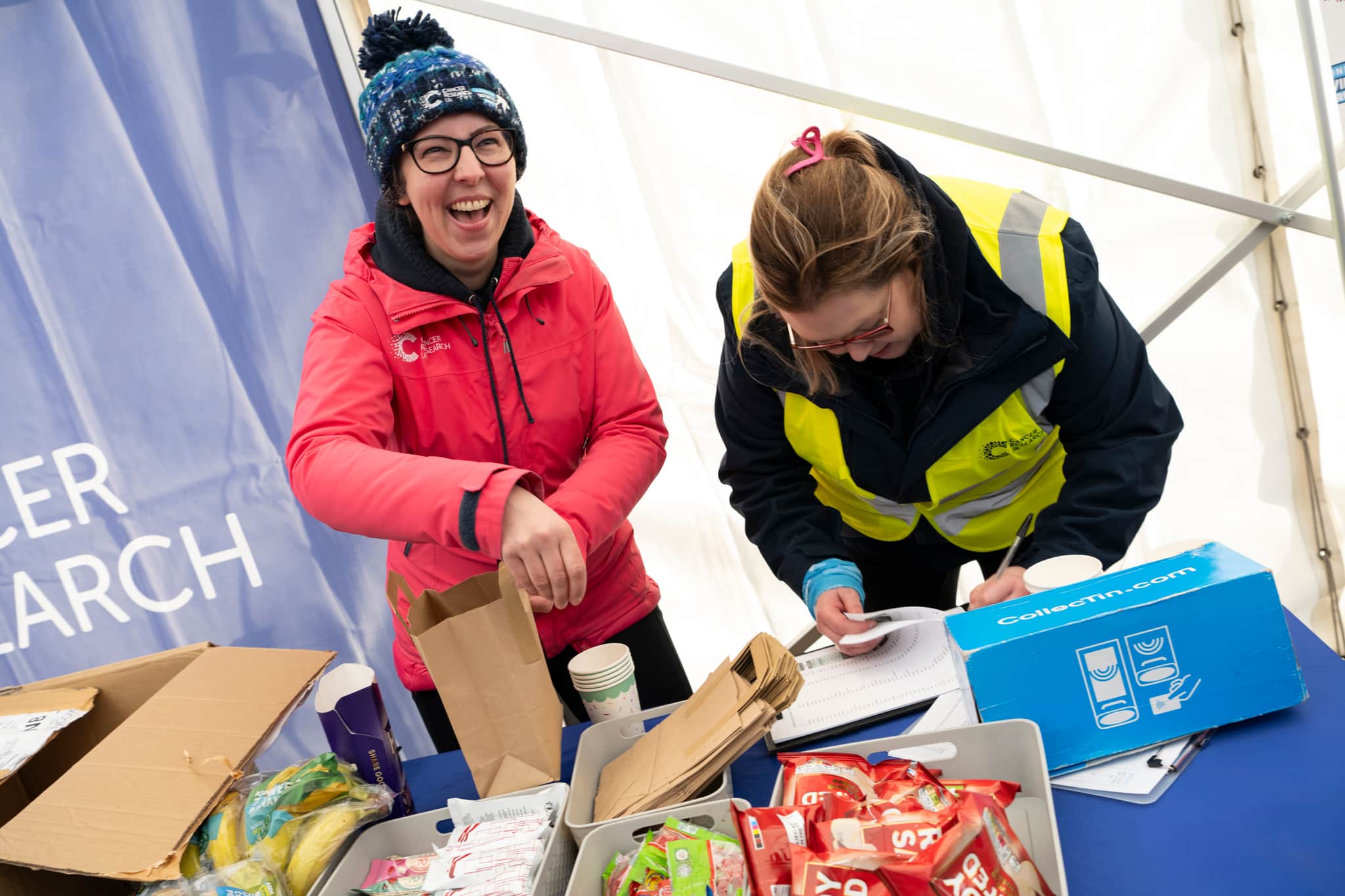 Volunteers at Winter Run 2024. They are laughing and having fun.
