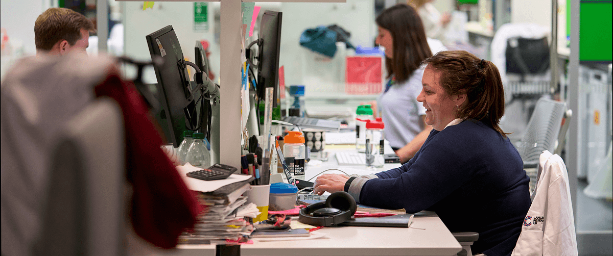 Image of researchers sitting in an office having a conversation.