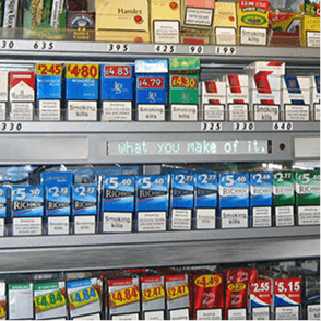 A photo of cigarette packs in a shop.