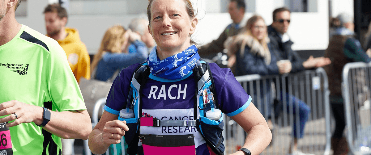A Cancer Research UK Brighton Marathon runner, smiling.