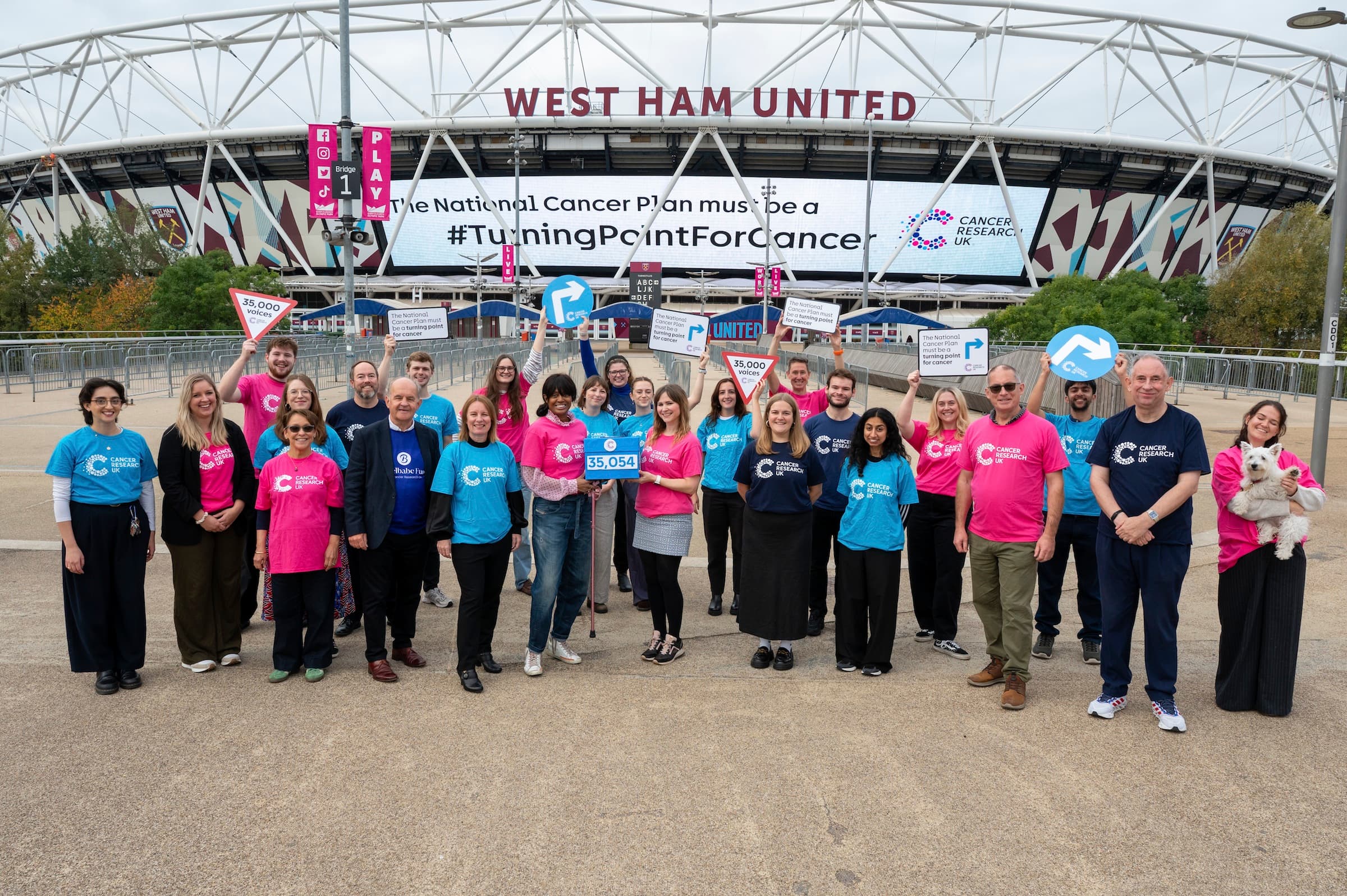 A photo of a group of campaigners in front of the London Stadium.