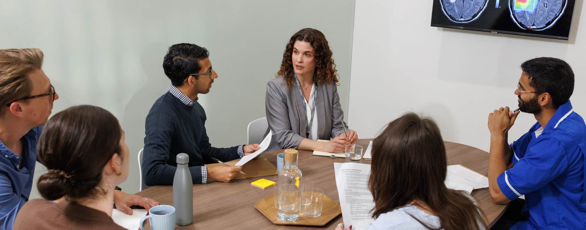 A team of doctors reviewing a patient's medical file.