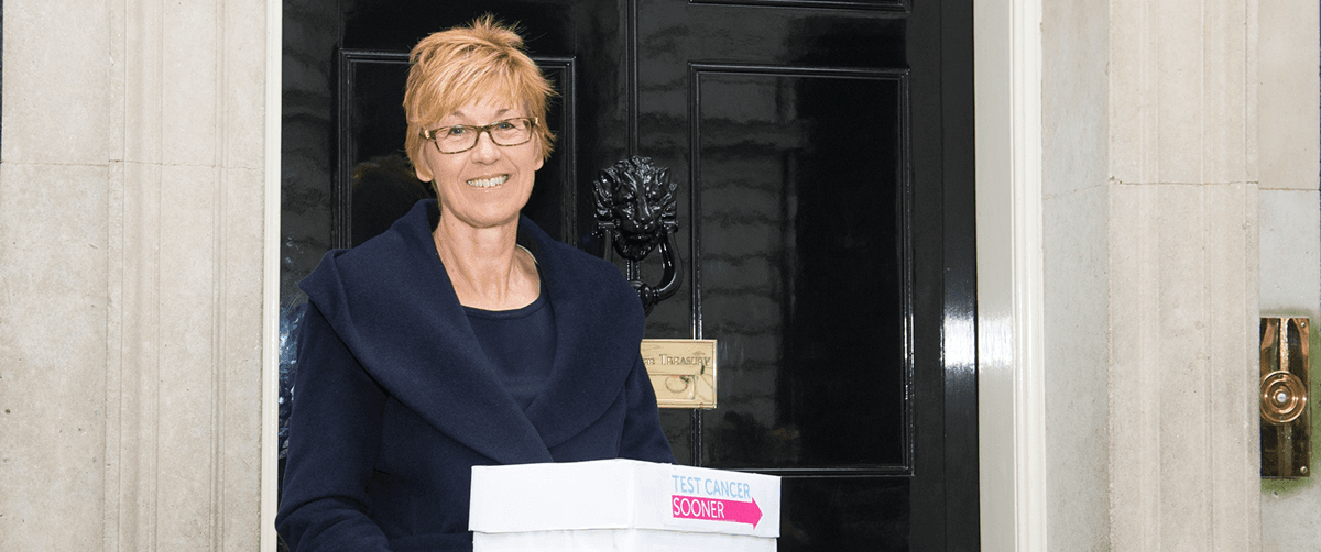 A photo of a Campaigns Ambassador in front of number 10.