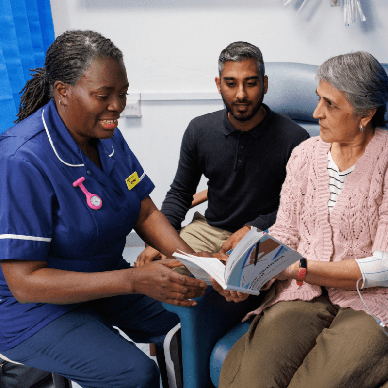 Health professional speaking to patient and carer.