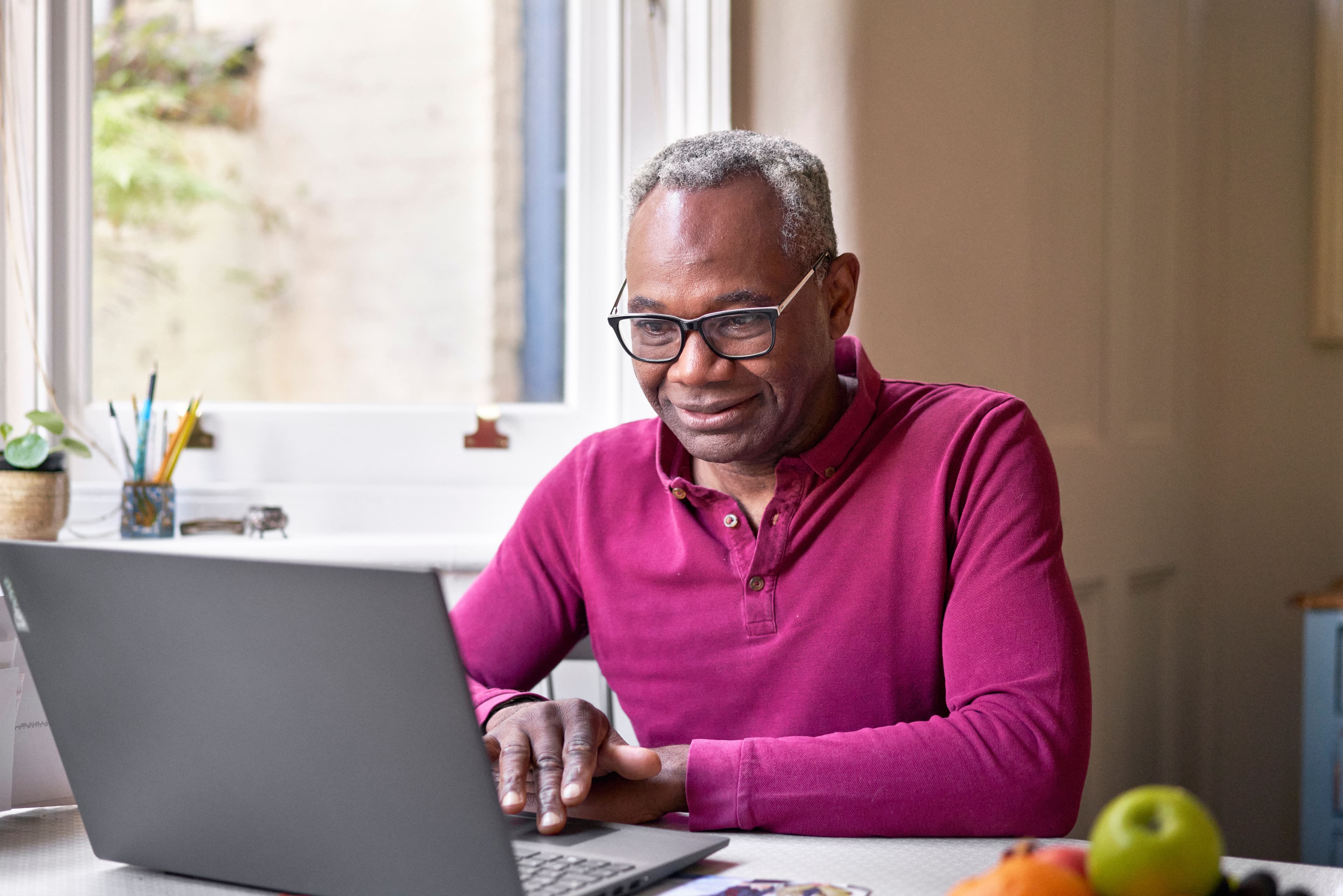 A man searching for more information on his laptop.