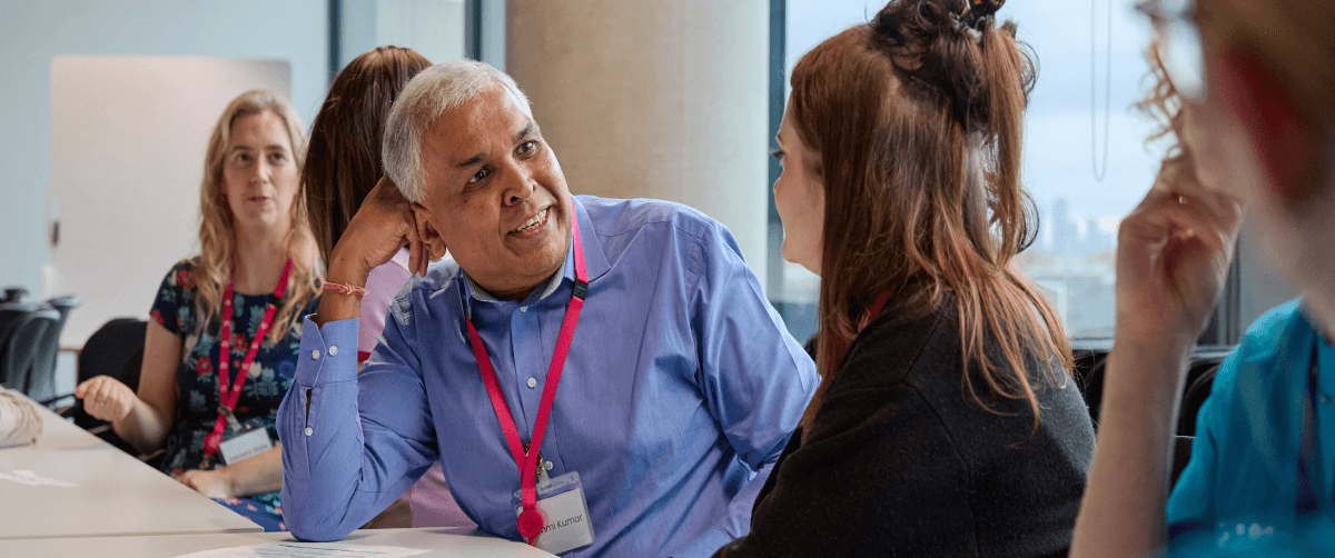 A photo of two Cancer Insights Panel members talking.