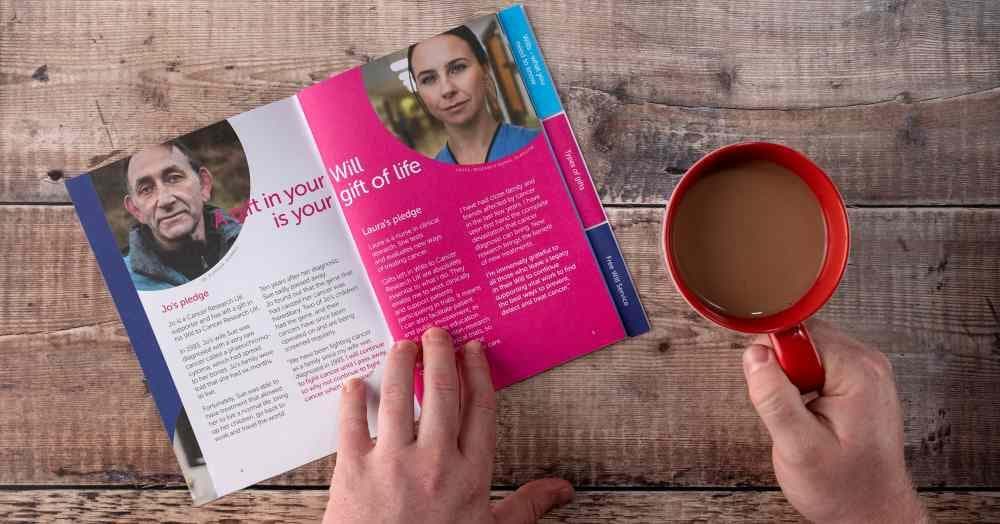 A 'Gift in Will' pack open on a table beside a cup of tea.