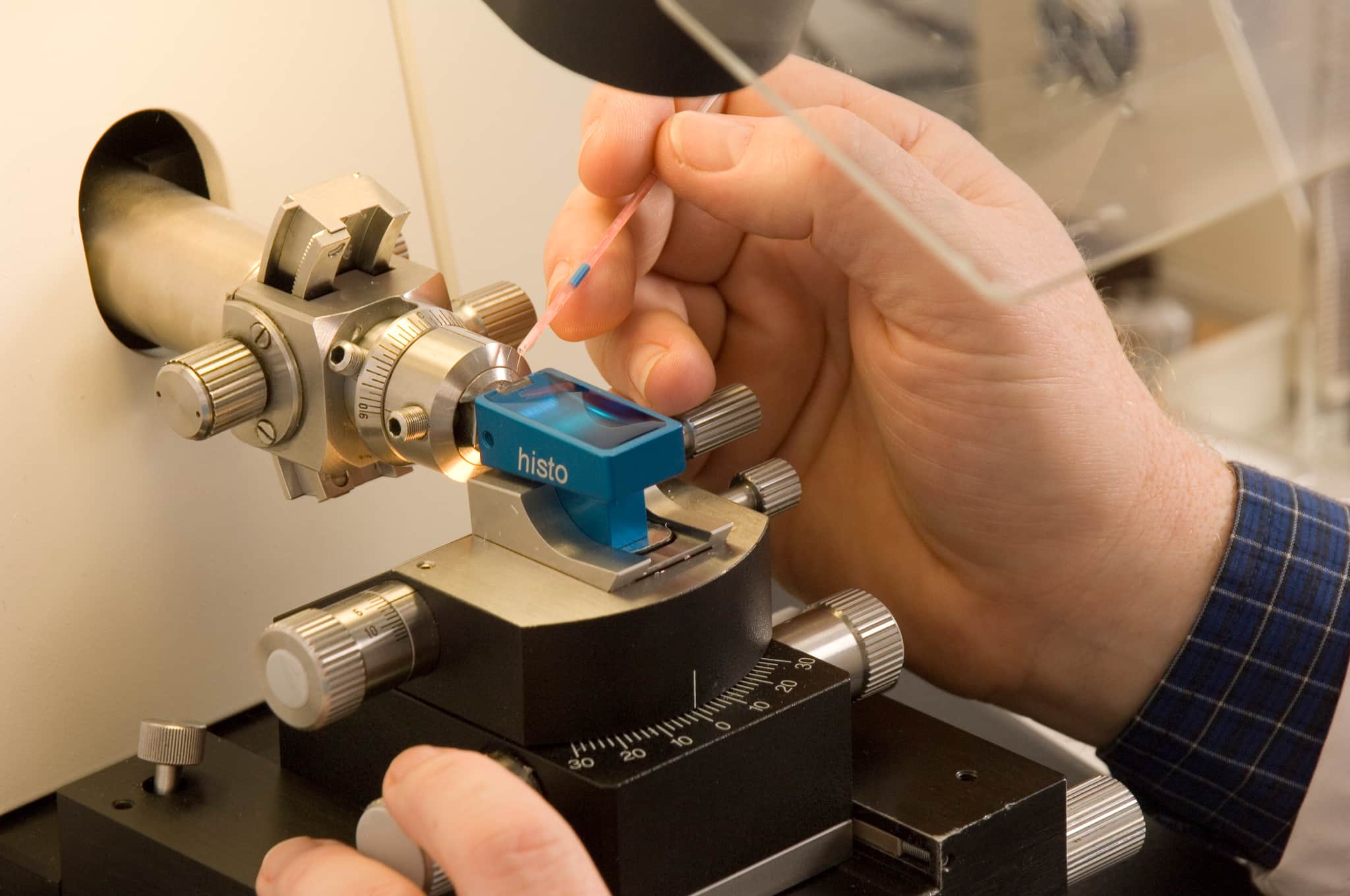 A scientist using a microscope.