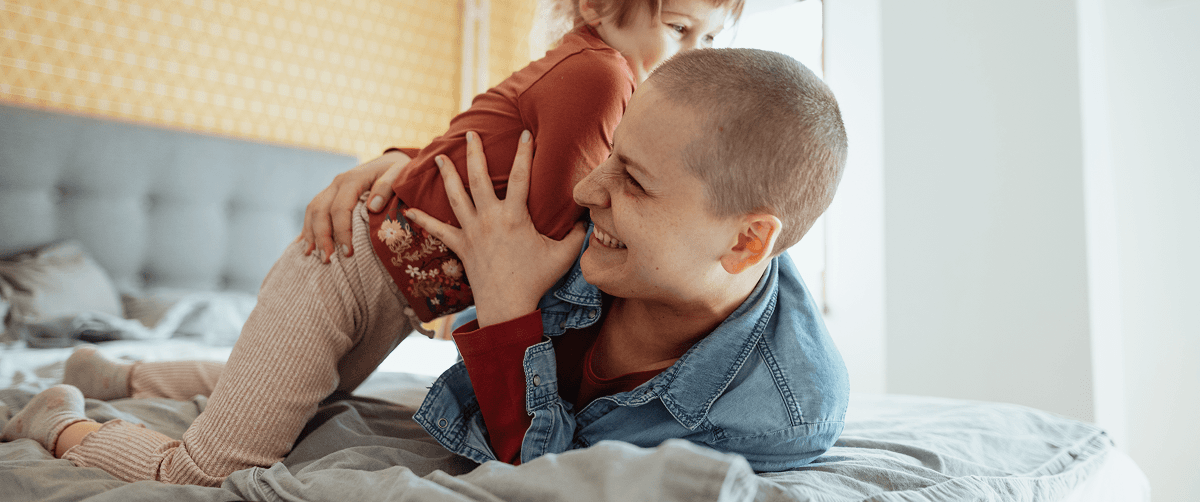 A photo of a mother with her child laughing.