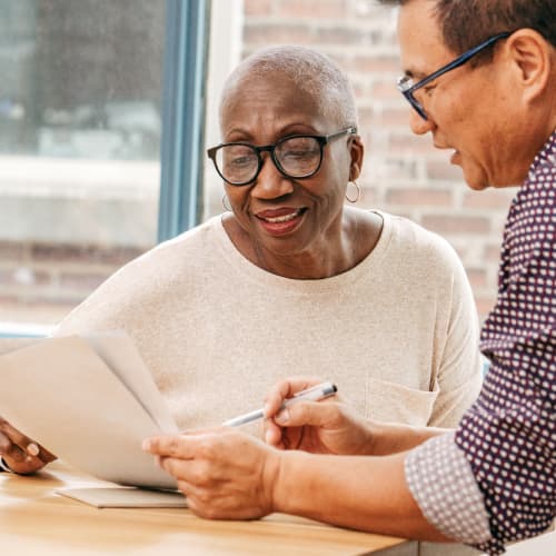 A man and woman reading through a document.
