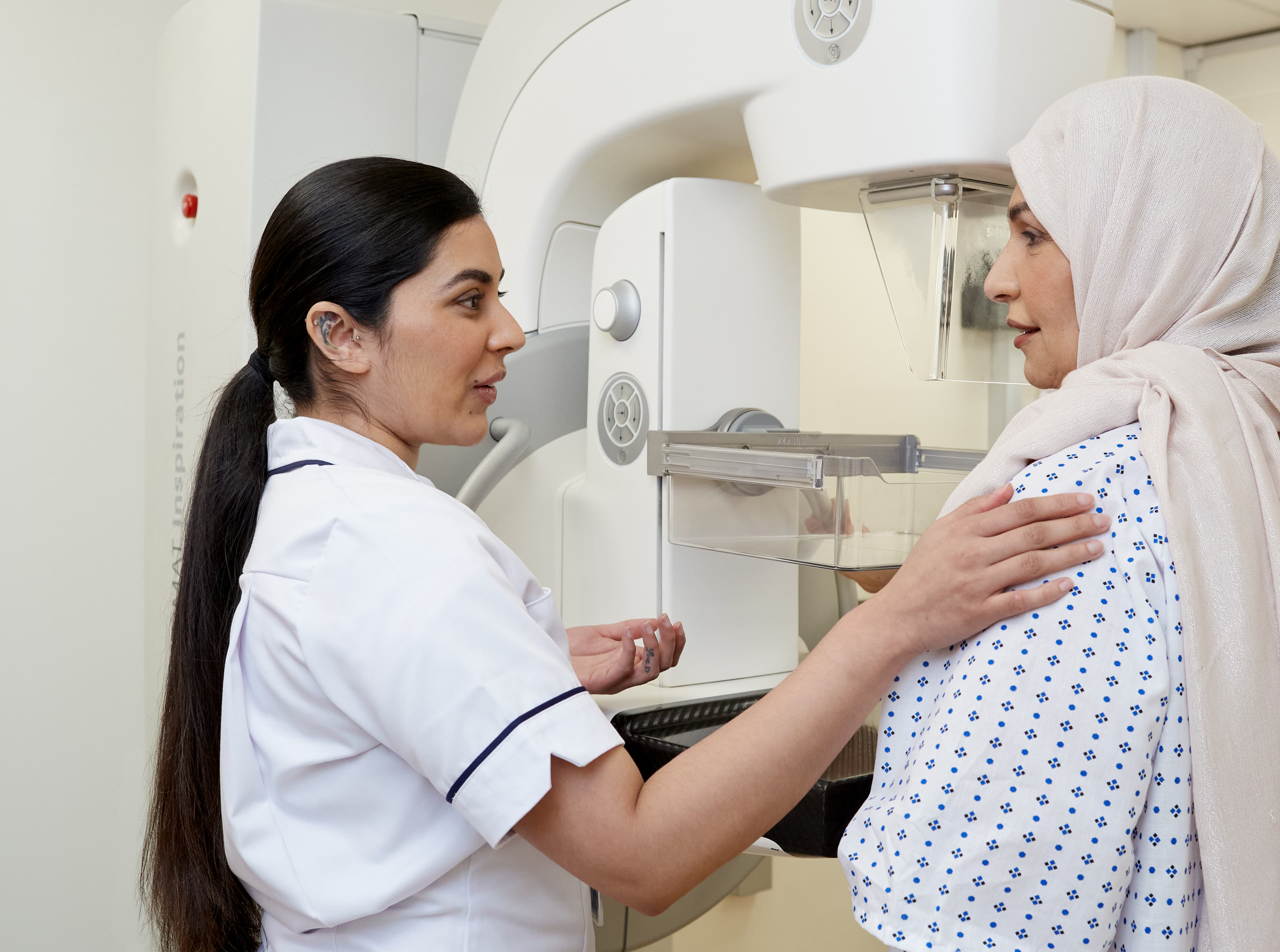 A mammographer with a patient.