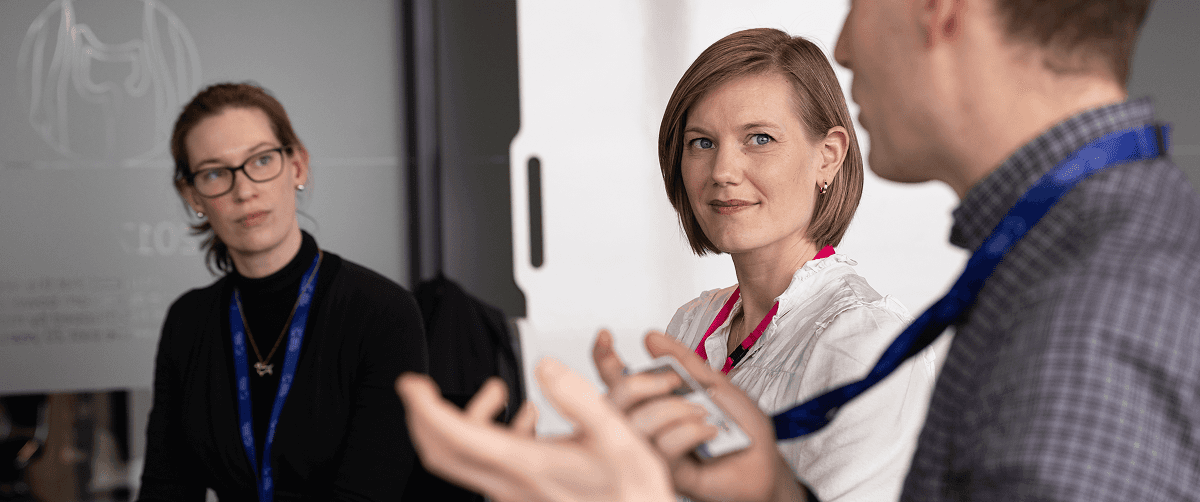 Three people in a meeting.