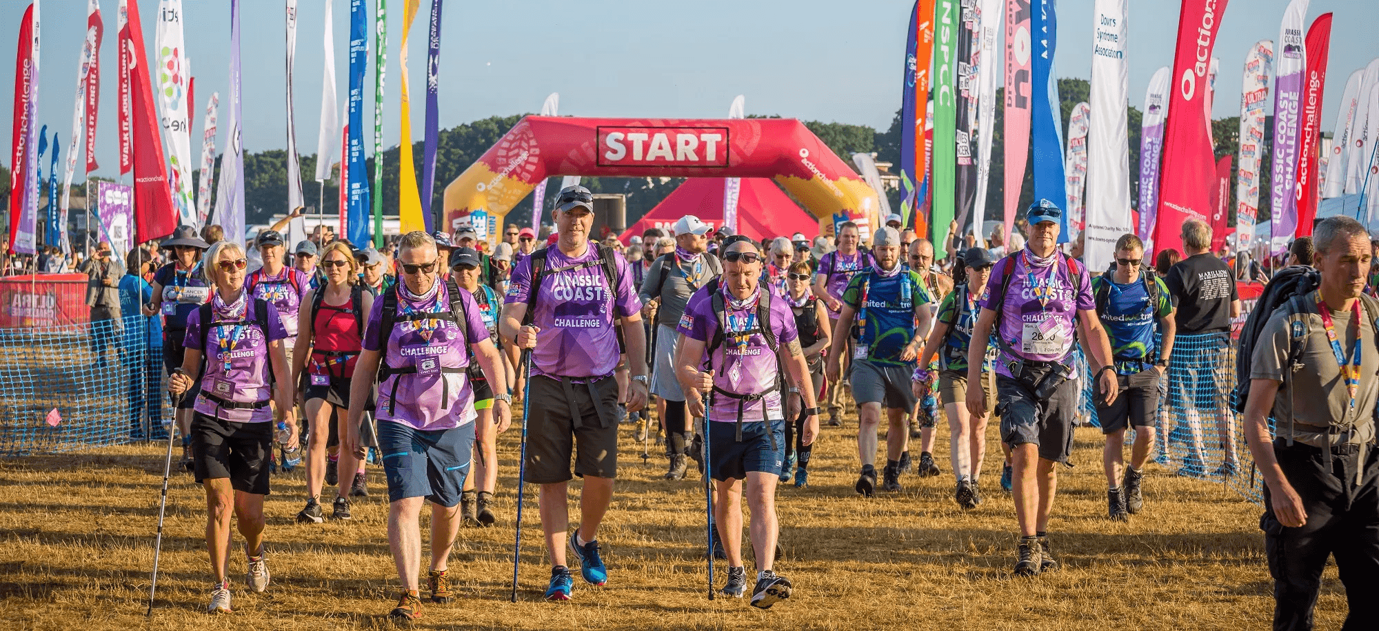 A group of walkers at the start line of their trek event.